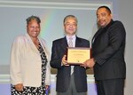 Ke Liu, M.D., receives a certificate of appreciation from DLA Chief of Staff Renee Roman and EEO and Diversity Director Ferdinand ‘Leo’ LeCompte April 10.