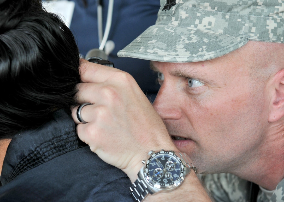 U.S. Army Lt. Col. Derrick Kooker, a medical provider with the Wyoming National Guard assigned to Beyond the Horizon 2017, checks the inner ear canal of a patient during a medical readiness event held at Macal River Park in San Ignacio, Belize May 8, 2017. This is the second of three health events held by BTH 2017. Beyond the Horizon is a U.S. Southern Command-sponsored, Army South-led exercise designed to provide humanitarian and engineering services to communities in need, demonstrating U.S. support for Belize.