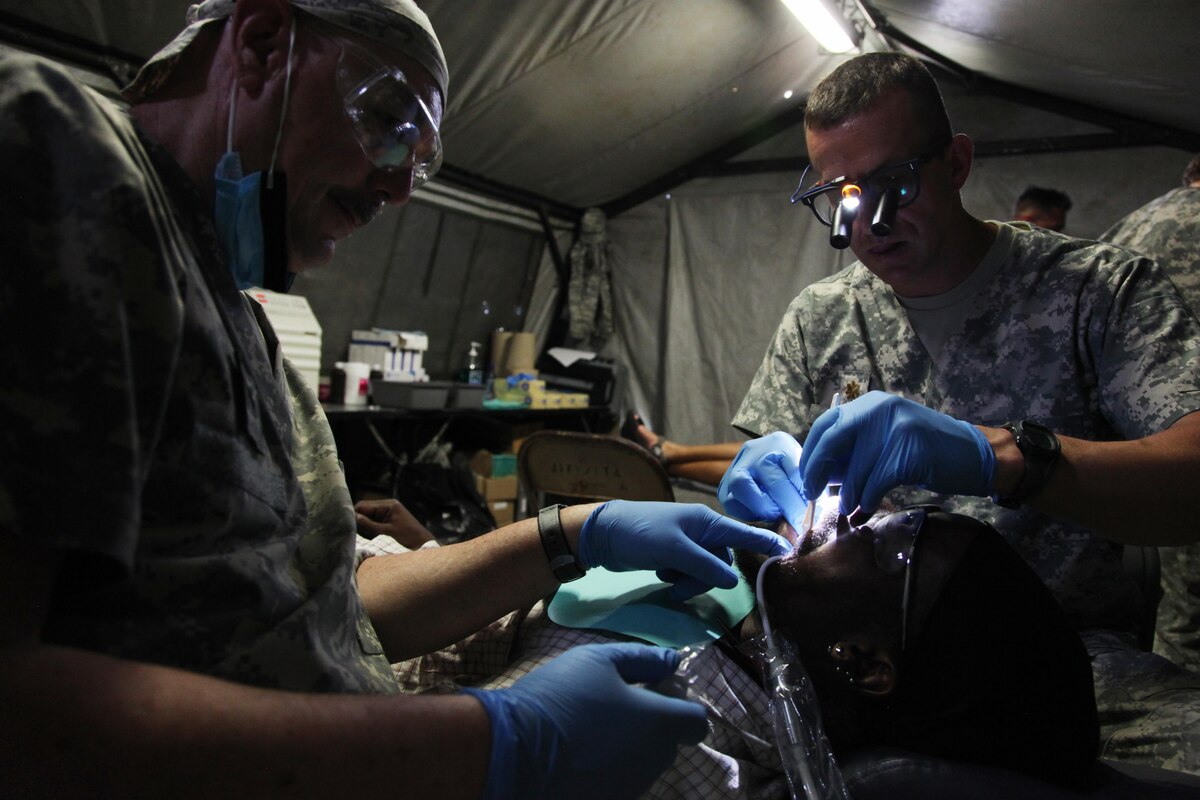 U.S. Army dental staff, with the Wyoming National Guard Medical Detachment, remove the tooth of a Belizean boy during a medical readiness event held in San Ignacio, Belize, May 09, 2017. This is the second of three medical events that are scheduled to take place during Beyond the Horizon 2017. BTH 2017 is a U.S. Southern Command-sponsored, Army South-led exercise designed to provide humanitarian and engineering services to communities in need, demonstrating U.S. support for Belize. (U.S. Army photo by Sgt. Joshua E. Powell)