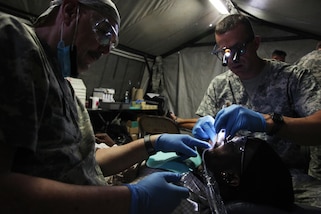 U.S. Army dental staff, with the Wyoming National Guard Medical Detachment, remove the tooth of a Belizean boy during a medical readiness event held in San Ignacio, Belize, May 09, 2017. This is the second of three medical events that are scheduled to take place during Beyond the Horizon 2017. BTH 2017 is a U.S. Southern Command-sponsored, Army South-led exercise designed to provide humanitarian and engineering services to communities in need, demonstrating U.S. support for Belize. (U.S. Army photo by Sgt. Joshua E. Powell)