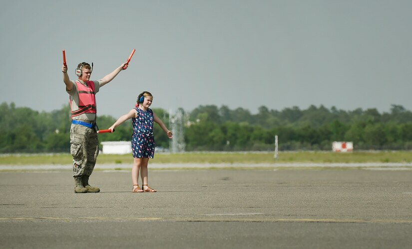 U.S. Air Force Airman 1st Class Dennis Powers, left, 437th Aircraft Maintenance Squadron, and Bella Berg, 8 year old daughter of Chief Master Sgt. Kristopher Berg, 437th Airlift Wing command chief, taxis in a C-17 Globemaster III during Chief Master Sgt. Berg’s final flight at Joint Base Charleston, S.C., May 11, 2017. Chief Master Sgt. Berg’s wife, Amy, Airmen and civilians of JB Charleston were present to congratulate him during the event. 