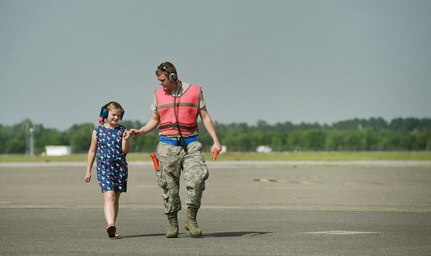 Bella Berg, left, 8 year old daughter of Chief Master Sgt. Kristopher Berg, 437th Airlift Wing command chief, and U.S. Air Force Airman 1st Class Dennis Powers, right, 437th Aircraft Maintenance Squadron, finish taxiing in a C-17 Globemaster III as part of Chief Master Sgt. Berg’s final flight at Joint Base Charleston, S.C., May 11, 2017. Chief Master Sgt. Berg’s wife, Amy, Airmen and civilians of JB Charleston were present to congratulate him during the event. 