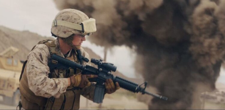 Capt. Erin Demchko portrays a convoy commander engaged in a firefight during the filming of "Battle Up," a new commercial published by the Marine Corps Recruiting Command May 12, 2017. "Battle Up," like the other work in the recently-launched campaign, is aimed at the recruitable population and their influencers – parents, teachers, coaches and community leaders. (Courtesy Screen Shot)