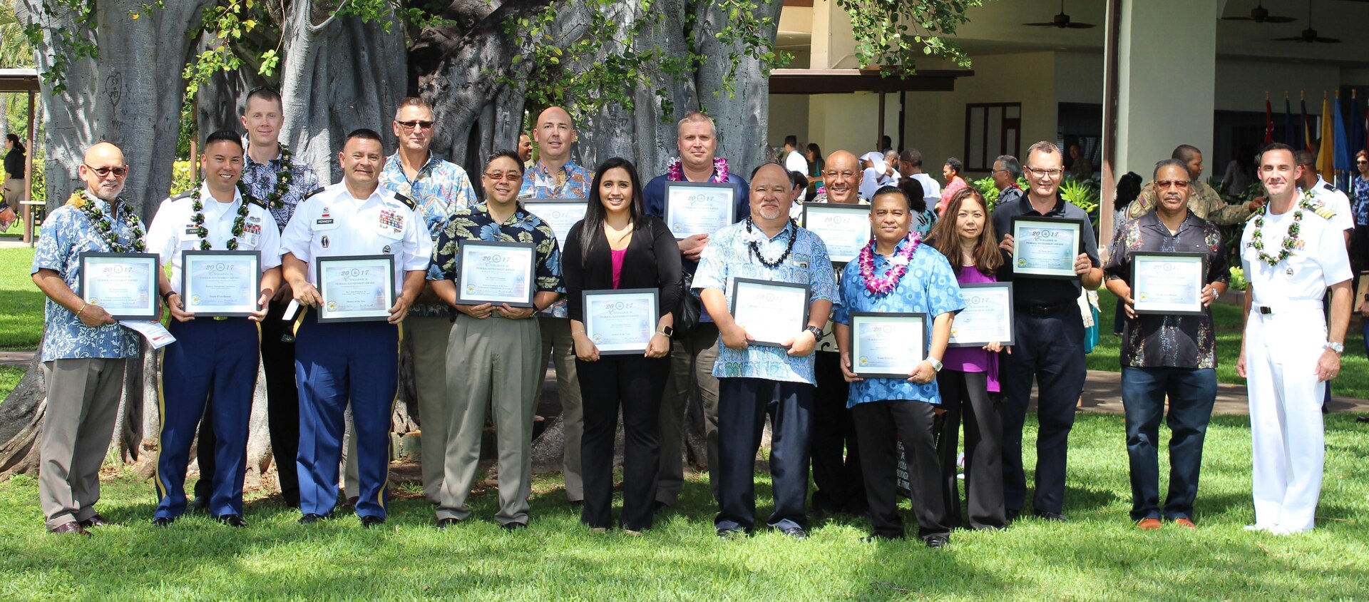 Fifteen Defense Logistics Agency Pacific awardees stand with DLA Pacific Commander Navy Capt. Timothy Daniels at the 61st Annual Excellence in Federal Government Awards held at Hickam Officer's Club, Joint Base Pearl Harbor-Hickam, Hawaii, May 6.