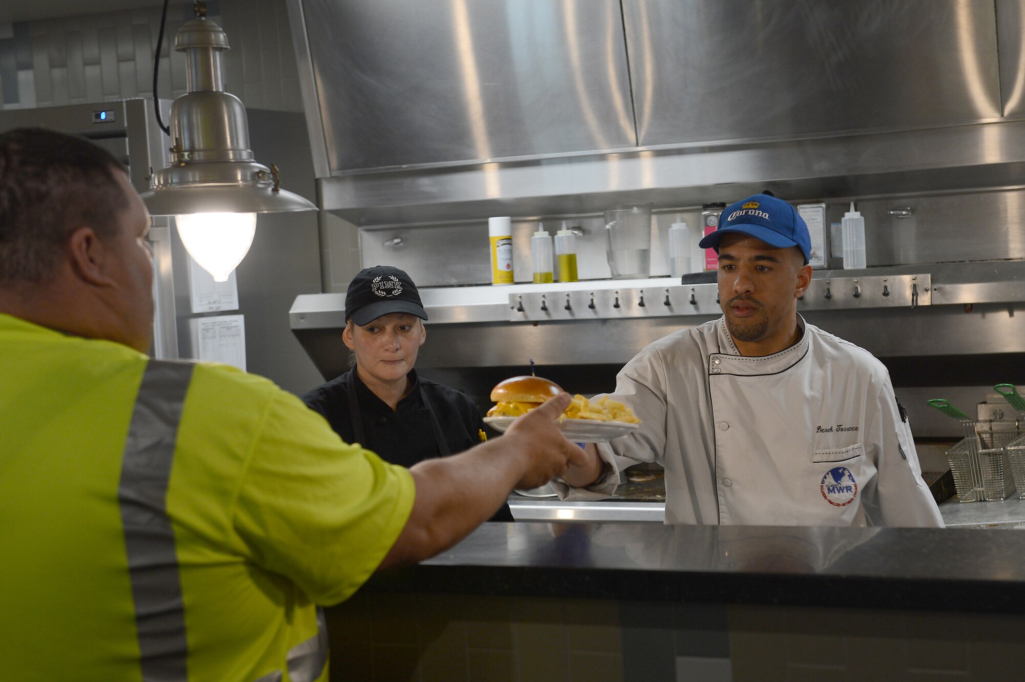 Derek Torrence, McChord Club executive chef, gives a customer his lunch at McChord Grill, May 10, 2017 at Joint Base Lewis-McChord, Wash. Here at McChord, the club provides services for Airman Leadership School graduations, weddings, retirements, promotions, farewells and during lunch at McChord Grill. (U.S. Air Force photo/Senior Airman Divine Cox)