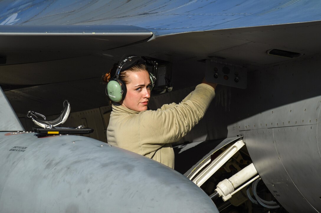 Senior Airman Christina Smith, a crew chief assigned to the 301st Fighter Wing, Naval Air Station Fort Worth Joint Reserve Base, Texas, performs pre-flight maintenance on an F-16 Fighting Falcon aircraft May 3 at Hill Air Force Base, Utah. The F-16s were at Hill AFB and the Utah Test and Training Range participating in Combat Hammer, an air-to-ground weapons evaluation exercise. (U.S. Air Force/R. Nial Bradshaw)