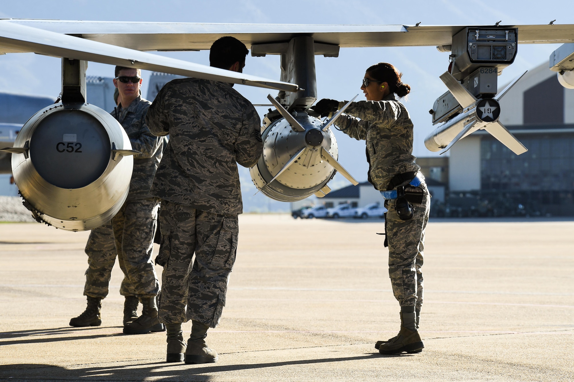 Weapons Airmen assigned to the 136th Maintenance Squadron, Naval Air Station Fort Worth Joint Reserve Base, Texas, perform pre-flight maintenance on an F-16 Fighting Falcon aircraft May 3 at Hill Air Force Base, Utah. The F-16s were at Hill AFB and the Utah Test and Training Range participating in Combat Hammer, an air-to-ground weapons evaluation exercise. (U.S. Air Force/R. Nial Bradshaw)