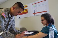 Spc. William Guardiola, a horizontal construction engineer with the 266th Ordnance Company out of Aguadilla, Puerto Rico, applies fake blood on a civilian role-player as part of the Guardian Response exercise April 29, 2017, at the Muscatatuck Urban Training Center, Ind. Nearly 4,100 Soldiers from across the country are participating in Guardian Response 17, a multi-component training exercise to validate U.S. Army units’ ability to support the Defense Support of Civil Authorities (DSCA) in the event of a Chemical, Biological, Radiological, and Nuclear (CBRN) catastrophe. (U.S. Army Reserve photo by Spc. Christopher Hernandez)