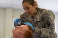 Pvt. Elsamari Figueroa, an ammunition specialist with the 266th Ordnance Company out of Aguadilla, Puerto Rico, prepares a fake head wound on a civilian role-player as part of the Guardian Response exercise April 29, 2017, at the Muscatatuck Urban Training Center, Ind. Nearly 4,100 Soldiers from across the country are participating in Guardian Response 17, a multi-component training exercise to validate U.S. Army units’ ability to support the Defense Support of Civil Authorities (DSCA) in the event of a Chemical, Biological, Radiological, and Nuclear (CBRN) catastrophe. (U.S. Army Reserve photo by Spc. Christopher Hernandez)