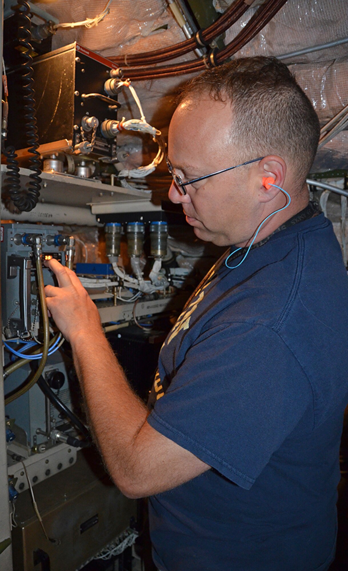 Kristian Hodges, integrated avionics, inspects the Central Air Data Computeer (CADC) inside the C-5 May 3, 2017, at Robins Air Force Base, Ga. (U.S. Air Force photo by Tech. Sgt. Kelly Goonan/released)