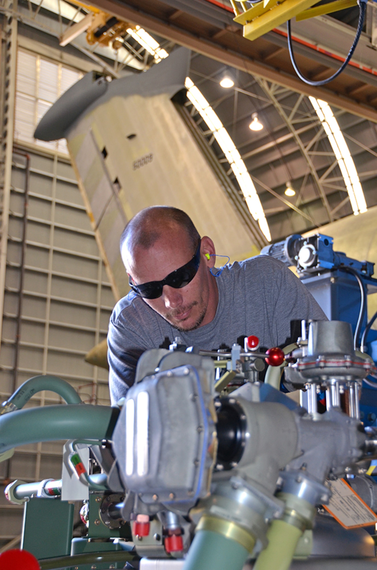 Ian Bare, Fuels, inspects a removed C-5 Fuel Tank Pressurization System (Dewar). Two 800-liter Dewar storage tanks pressurize the C-5 Galaxy’s fuel tanks and are located on each side of the aircraft. (U.S. Air Force photo/Tech. Sgt. Kelly Goonan/released)