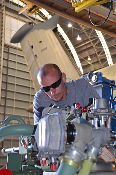 Ian Bare, Fuels, inspects a removed C-5 Fuel Tank Pressurization System (Dewar). Two 800-liter Dewar storage tanks pressurize the C-5 Galaxy’s fuel tanks and are located on each side of the aircraft. (U.S. Air Force photo/Tech. Sgt. Kelly Goonan/released)