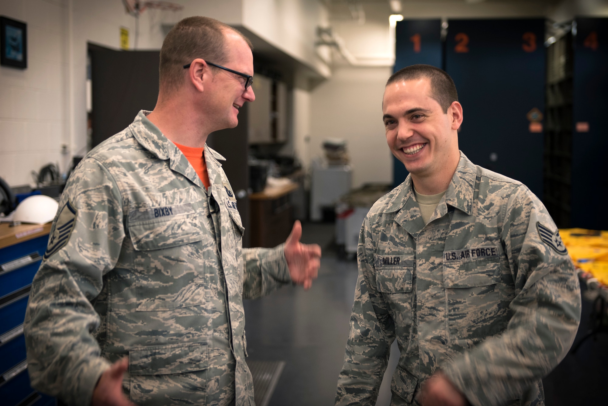 U.S. Air Force Master Sgt. Brent Bixby, left, the airfield management superintendent with the 182nd Operations Support Squadron, Illinois Air National Guard, and Staff Sgt. Ryan Miller, an aircrew flight equipment craftsman with the 182nd Operations Support Squadron, share a laugh during drill weekend in Peoria, Ill., May 6, 2017. Bixby provides Miller personal and professional guidance by serving as his mentor. (U.S. Air National Guard photo by Tech. Sgt. Lealan Buehrer)