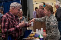Airman 1st Class Allie Staffen, 91st Missile Maintenance Squadron facilities maintenance section technician, gives snacks to retired citizens at the annual Salute to Seniors event in Minot, N.D., May 9, 2017. Minot Air Force Base volunteers helped with security, serving food and drinks, handing out gifts, and escorting senior citizens to designated areas. (U.S. Air Force photo/Airman 1st Class Jonathan McElderry)