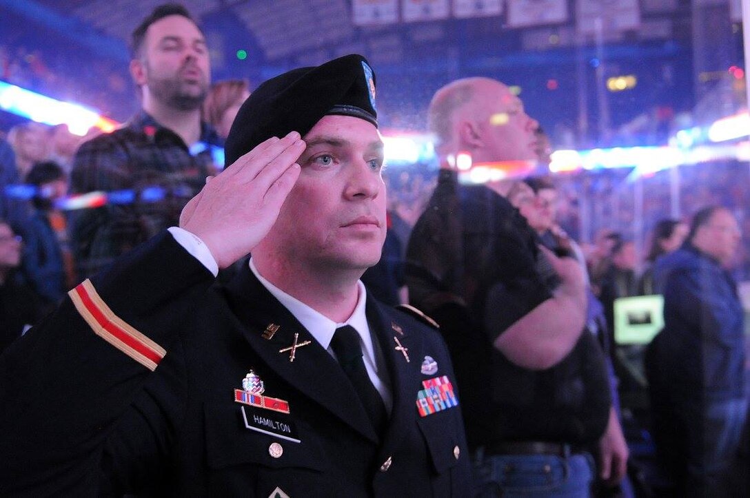 Army Reserve Maj. George Hamilton, 85th Support Command, renders a salute during the playing of the National Anthem at a Chicago Wolves game, April 8, 2017. Hamilton was honored there during an one-the-ice military salute.
(Photo by Sgt. Aaron Berogan)