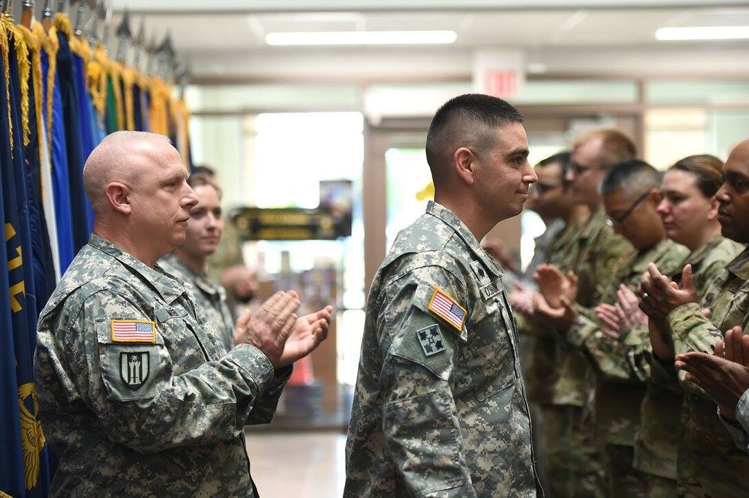 First Lt. Nicholas Osborn, center, 85th Support Command Chaplain’s office, receives a round of applause following his promotion to first lieutenant during a ceremony at the command headquarters, May 7, 2017.
(Photo by Sgt. Aaron Berogan)