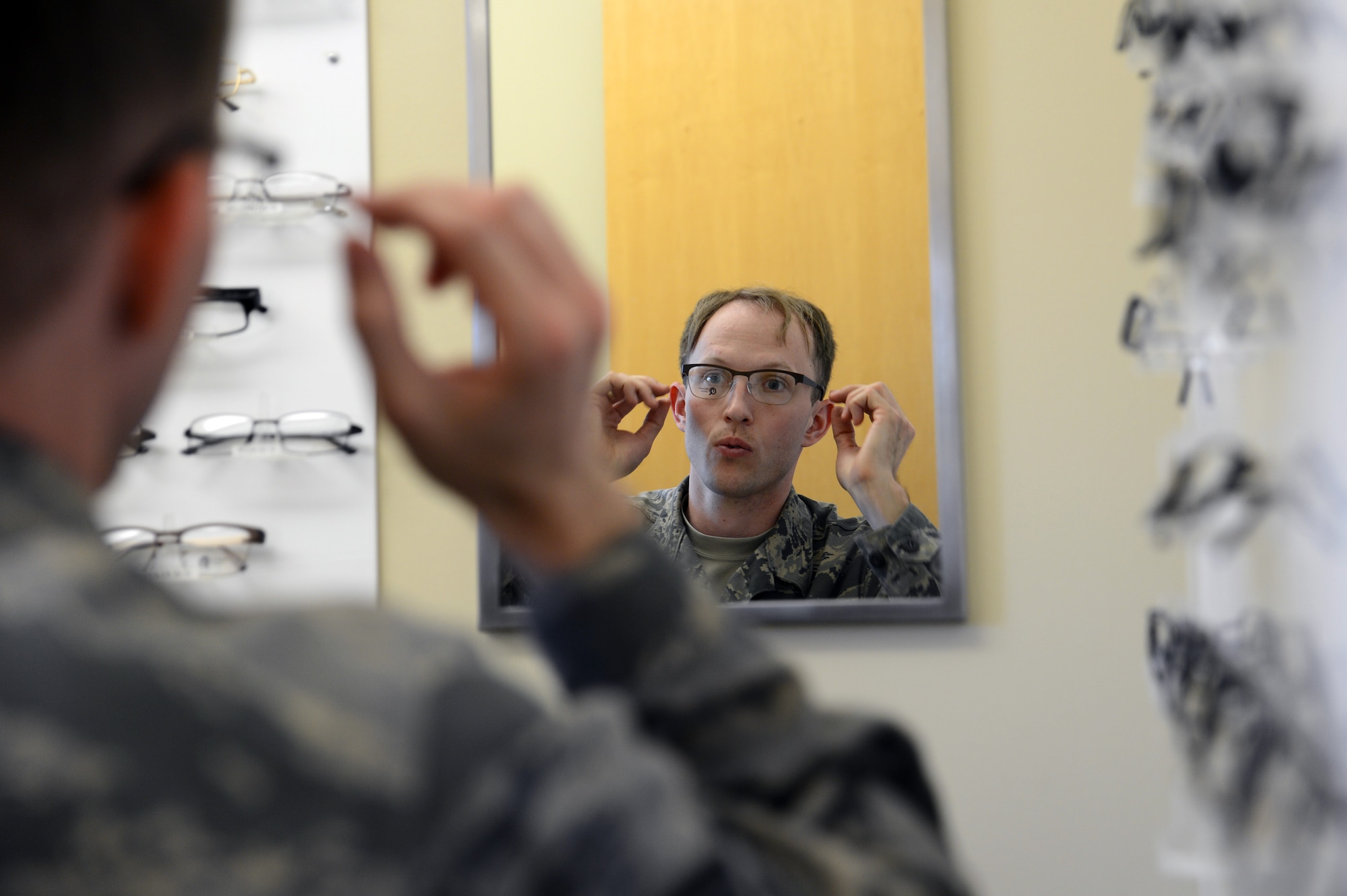 Staff Sgt. William Behl, 62nd Maintenances Squadron crewchief, looks at different eye glasses May 9, 2017, at Joint Base Lewis-McChord, Wash. The McChord Field optometry clinic provides military-issue spectacles and gas mask inserts, which include a frame of choice. (U.S. Air Force photo/Senior Airman Jacob Jimenez) 