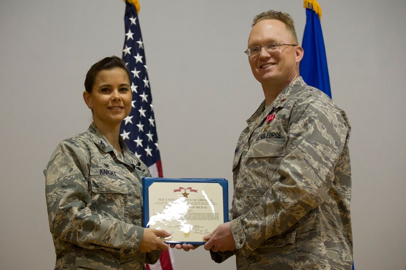 Col. Leslie Knight, 779th Medical Group Commander, presents a Bronze Star Medal to Maj. James O'Neill, 779th Surgical Operations Squadron operating room nurse, during a commander's call at Joint Base Andrews, Md., May 3, 2017. The medal was earned during a recent deployment. (Photo by Senior Master Sgt. Adrian Cadiz)