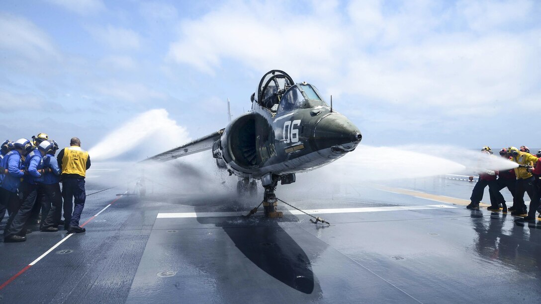 Sailors hose down an AV-8B Harrier during a flight deck fire drill aboard the USS Essex in the Pacific Ocean, May 9, 2017, as the amphibious assault ship conducts sea trials off the coast of Southern California. Navy photo by Petty Officer 3rd Class Chandler Harrell