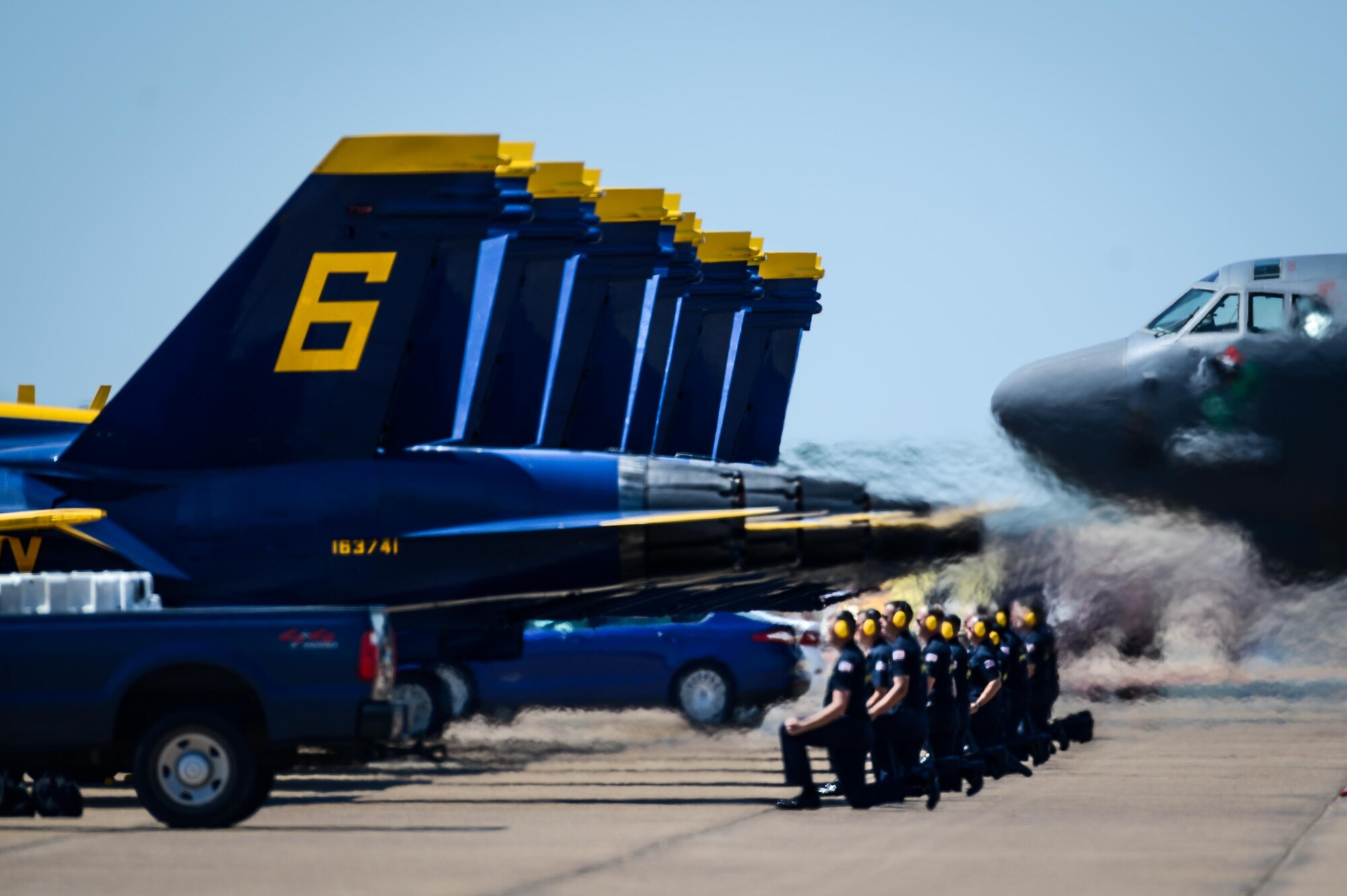 The U.S. Navy Flight Demonstration Team Blue Angels maintenance personnel take their positions behind F/A-18 Hornets prior to take off during the Defenders of Liberty Air Show at Barksdale Air Force Base, La., May 7, 2017. The mission of the Blue Angels is to showcase the pride and professionalism of the United States Navy and Marine Corps by inspiring a culture of excellence and service to country through flight demonstrations and community outreach. (U.S. Air Force photo/Senior Airman Mozer O. Da Cunha)