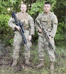 Sgt. David Peters, 2nd Squadron 101st Cavalry; and Staff Sgt. Masami Yamakado, 1st Battalion 69th Infantry, pose   for a team photo at the 26th Winston P. Wilson Sniper Championship at Ft. Chaffee Joint Maneuver Training Center, Ark. on April 27, 2017.
