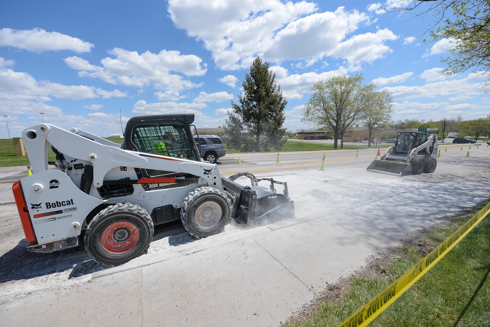 Members of the 55th Civil Engineer Squadron’s pavement and equipment team make repairs to SAC Blvd. May 3. Their 14-man crew is responsibility for all road, parking lot and runway repairs along with several other construction jobs. (U.S. Air Force photo by Zach Hada)