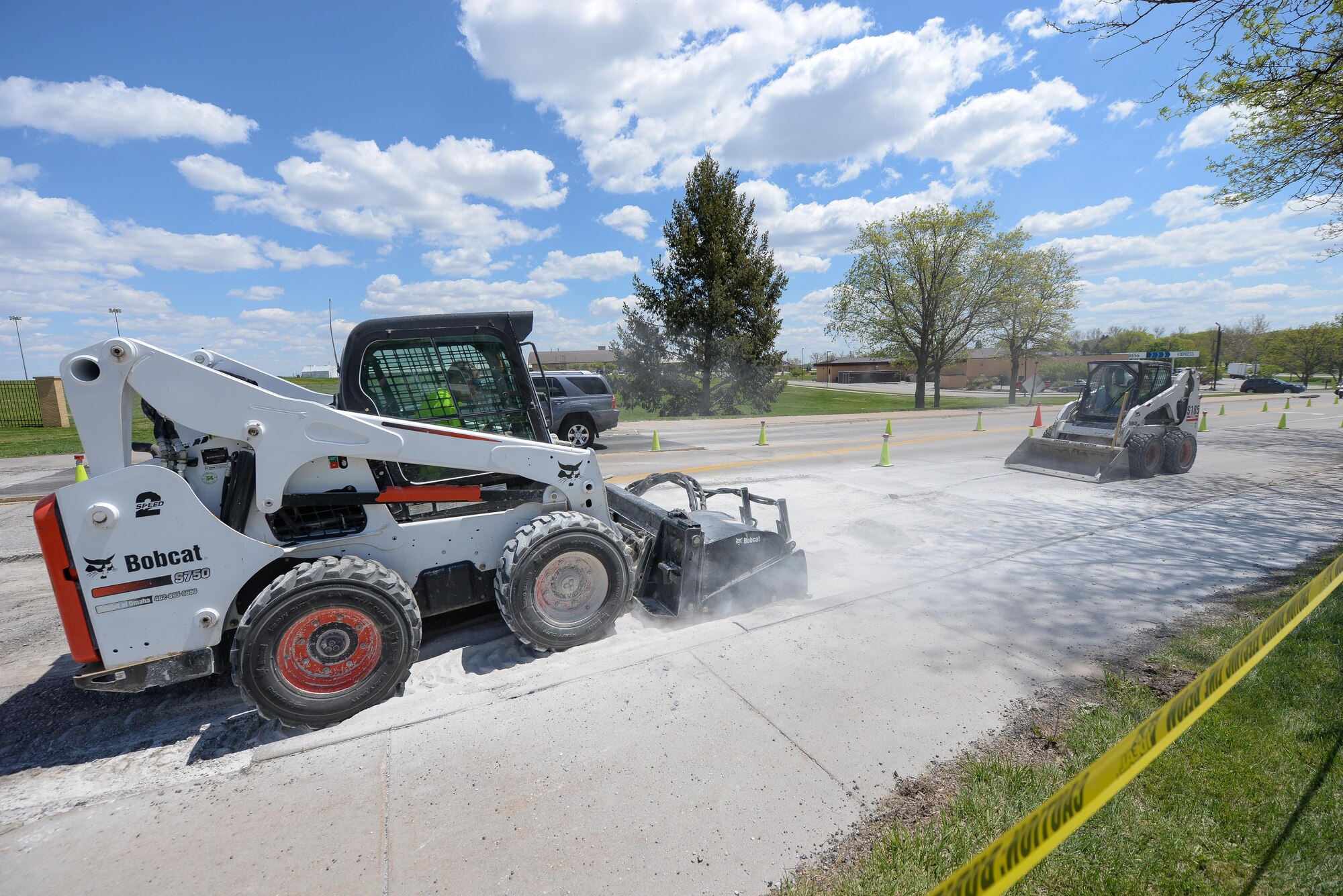 Members of the 55th Civil Engineer Squadron’s pavement and equipment team make repairs to SAC Blvd. May 3. Their 14-man crew is responsibility for all road, parking lot and runway repairs along with several other construction jobs. (U.S. Air Force photo by Zach Hada)