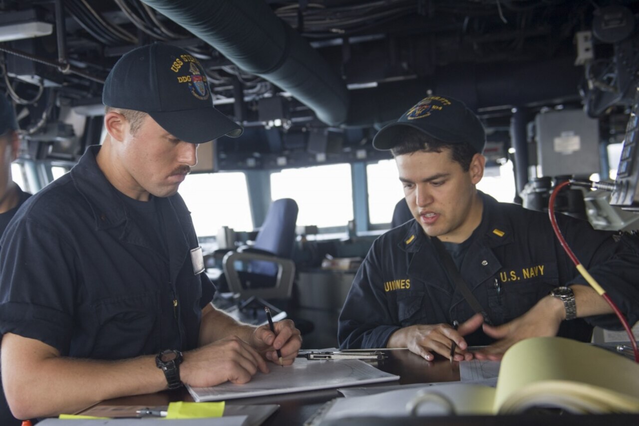 Navy Ensign Joseph Terranova, who hails from Melrose, Mass., and Navy Ensign Michael Quinones, a San Diego native, create stationing maneuvering boards aboard the guided-missile destroyer USS Sterett during a divisional tactics exercise. The event was conducted with the Singapore ship RSS Intrepid, Royal Thai navy ship HTMS Naresuan, and littoral combat ship USS Coronado in support of the Cooperation Afloat Readiness and Training multilateral exercise in the South China Sea, May 11, 2017. CARAT is a series of annual maritime exercises aimed at strengthening partnerships and increasing interoperability through bilateral and multilateral engagements ashore and at sea. Navy photo by Petty Officer 1st Class Byron C. Linder