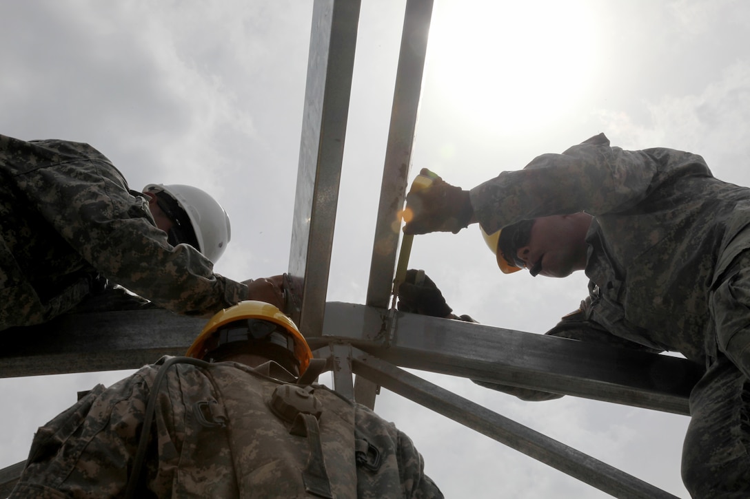 U.S. Army Spc. Judah Fenske, with the 485th Engineer Company, measures the anchor points of a support beam for the roof of the future medical clinic in Double Head Cabbage, Belize, May 10, 2017. This is one of five construction projects to take place in Belize for Beyond the Horizon 2017, a U.S. Southern Command-sponsored, Army South-led exercise designed to provide humanitarian and engineering services to communities in need, demonstrating U.S. support for Belize. (U.S. Army Photo by Sgt. Joshua E. Powell)