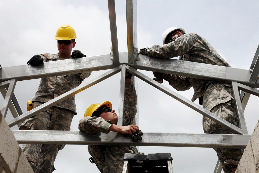 U.S. Soldiers, with the 485th Engineer Company, bolt down the support beam for the roof of the future medical clinic in Double Head Cabbage, Belize, May 10, 2017.Soldiers with the 485th are building the clinic as a part of Beyond the Horizon 2017, a U.S. Southern Command-sponsored, Army South-led exercise designed to provide humanitarian and engineering services to communities in need, demonstrating U.S. support for Belize. (U.S. Army Photo by Sgt. Joshua E. Powell)