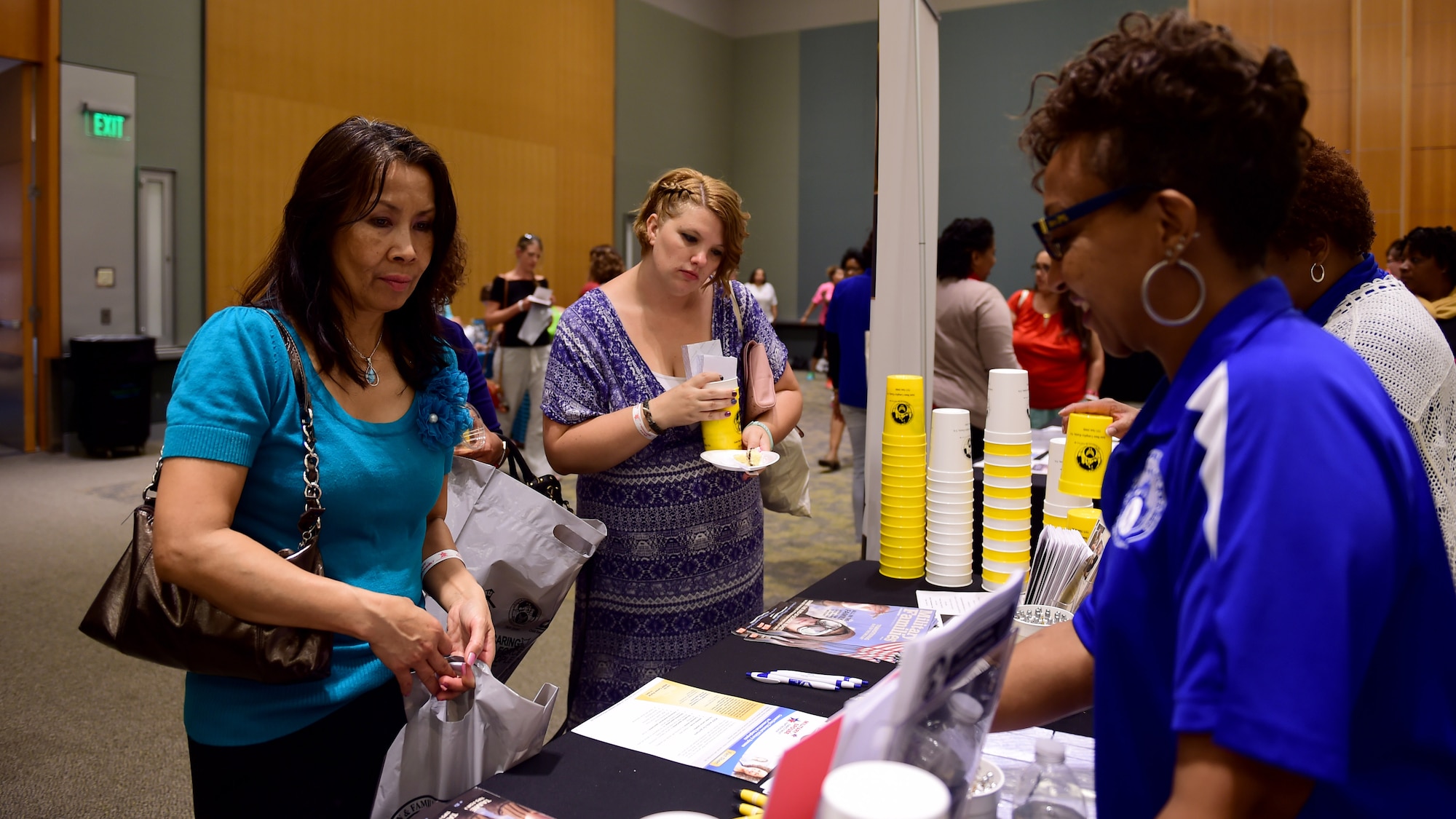 U.S. military spouses check-out the Airman and Family Readiness booth during the Evening Under the Stars event, in Hampton, Va., May 10, 2017. The event, which was open to military spouses from all branches, aimed to thank spouses for their support within the military community. (U.S. Air Force photo/Staff Sgt. Areca T. Bell) 