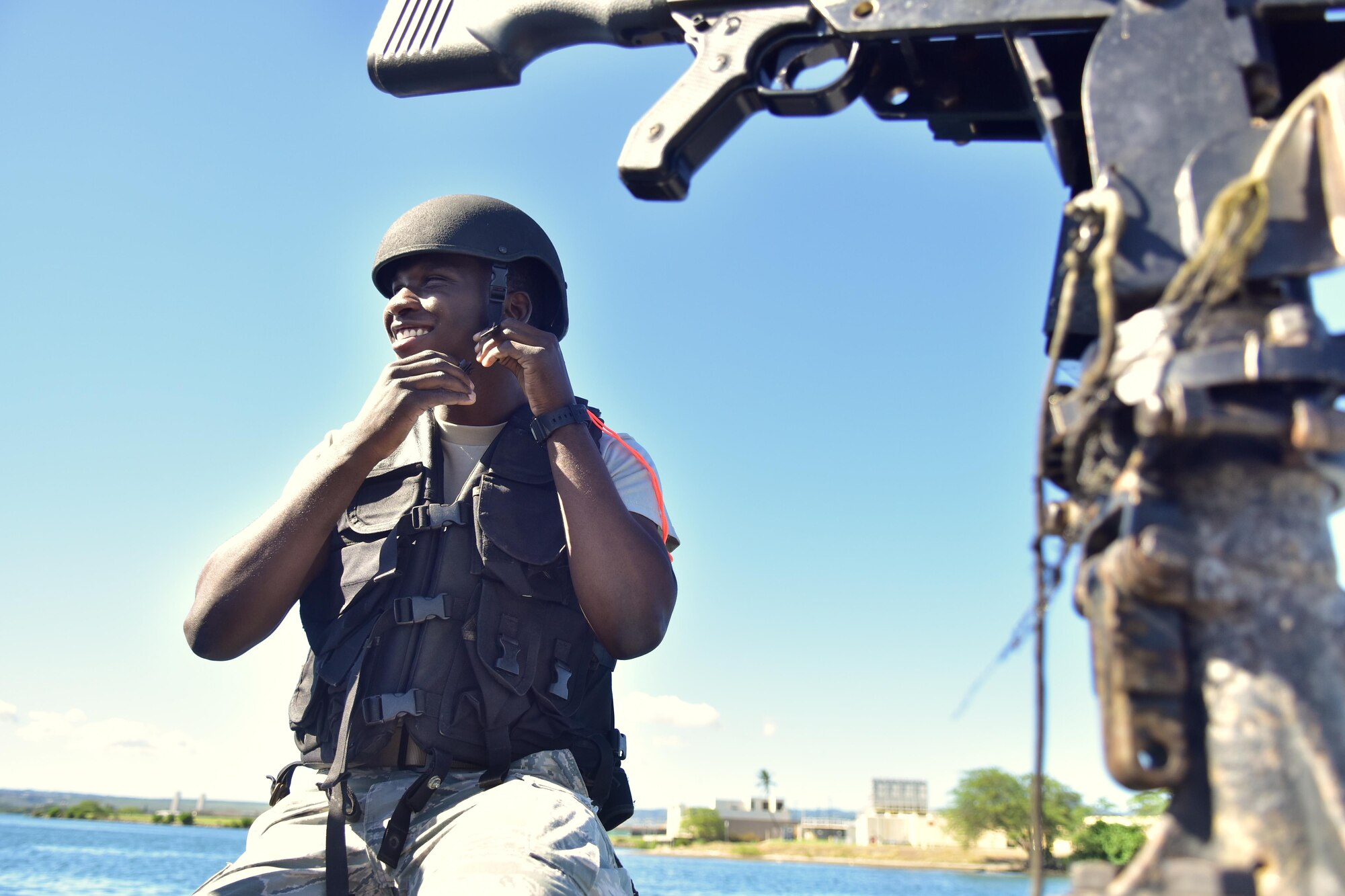 170501-F-MY948-786
Airman 1st Class Terez Bradshaw, 647 Air Base Group Security Forces defender, secures his helmet before patrolling the waters near Joint Base Pearl Harbor-Hickam. Bradshaw is one of four Airmen selected to train in a brand new Joint-Service integration program, which immerses Airmen and trains them for roles usually reserved for Naval personnel. (U.S. Air Force photo by Staff Sgt. Christopher Stoltz)