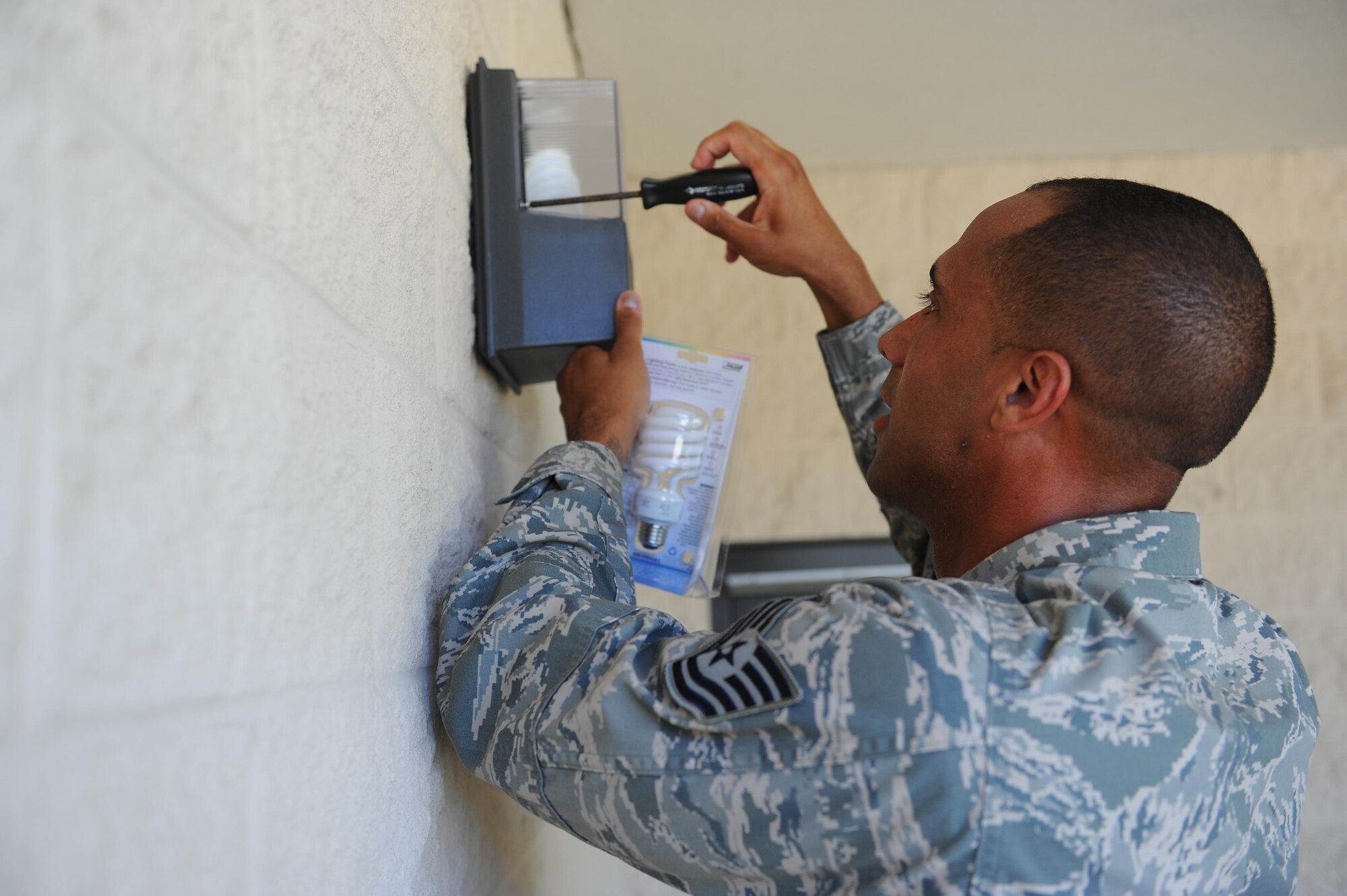 Tech. Sgt. Ryan Voisin, a fitness and sports section chief with the 1st Special Operations Force Support Squadron, replaces a lightbulb at the Aderholt Fitness Center, Hurlburt Field, Fla., May 10, 2017. The primary duty of a fitness and sports section chief is to oversee and ensure intramural sports are organized and running efficiently. (U.S. Air Force photo by Airman 1st Class Isaac O. Guest IV)