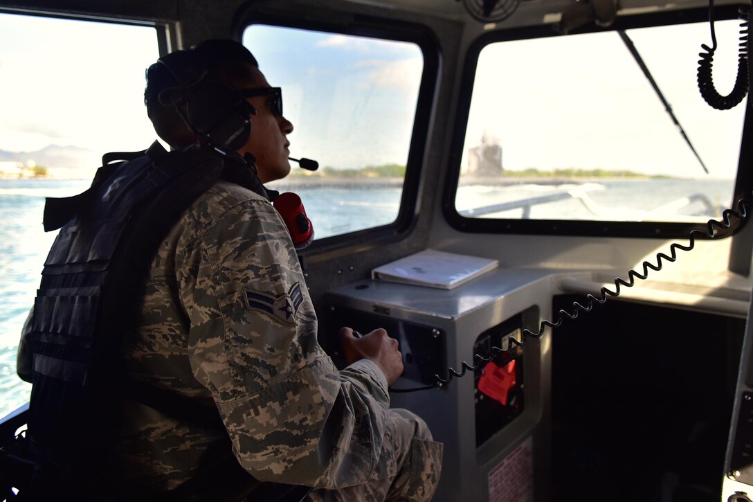 170501-F-MY948-887 
Airman 1st Class Gianni Santa Cruz, 647 Air Base Group Security Forces defender, communicates with the United States Coast Guard during his patrol the waters near Joint Base Pearl Harbor-Hickam. Santa Cruz is one of four Airmen selected to train in a brand new Joint-Service integration program, which immerses Airmen and trains them for roles normally reserved for Naval personnel. (U.S. Air Force photo by Staff Sgt. Christopher Stoltz)