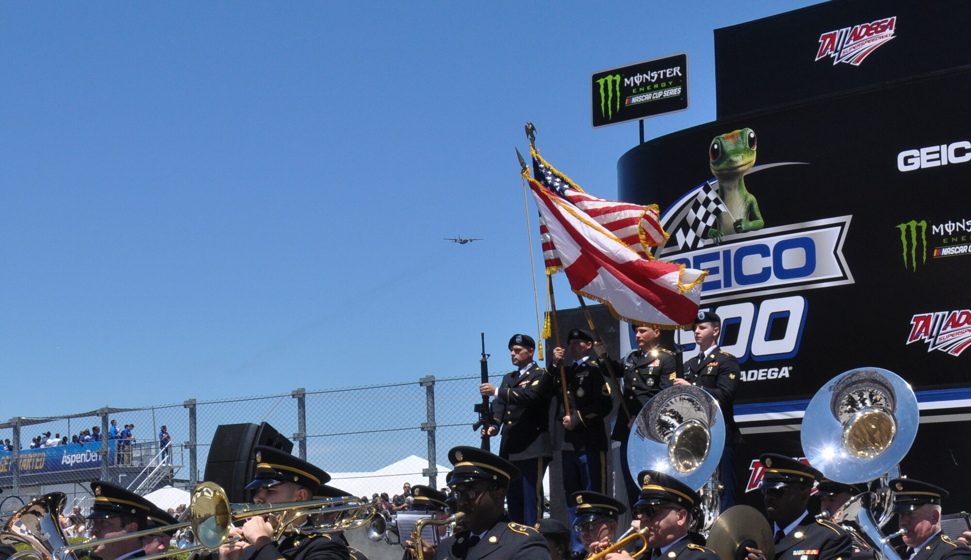 A C-130 Hercules assigned to the 908th Airlift Wing at Maxwell Air Force Base approaches the Army Honor Guard as they present the colors at the NASCAR Race in Talladega, Alabama on May 7, 2017. This is the second year the 908th AW conducted a flyover for NASCAR fans at Talladega. (U.S. Air Force photo by Staff Sgt. Malia Belton)