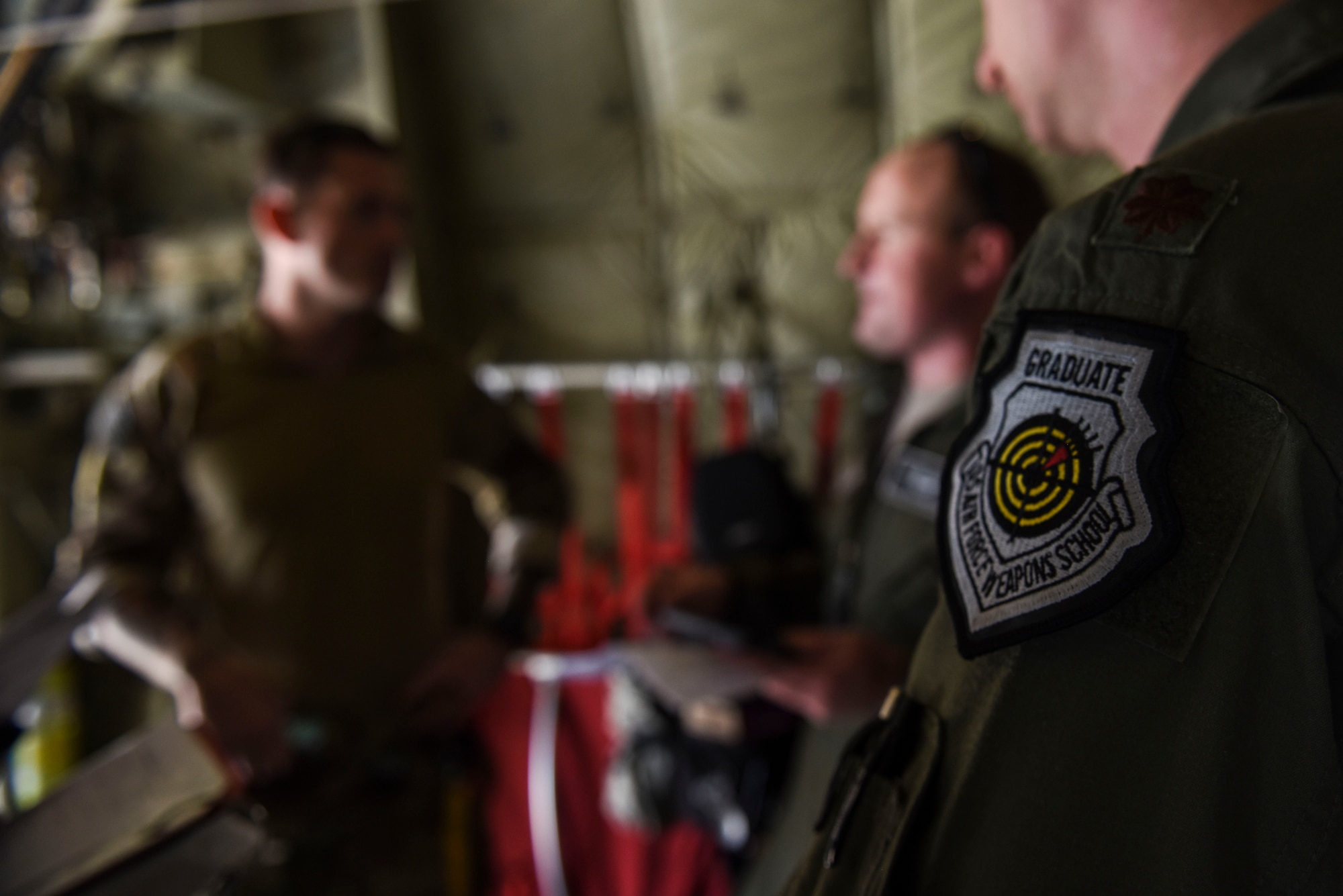 A 29th Weapons Squadron weapons officer and student conduct a preflight briefing with a combat controller before a military free fall jump, May 2, 2017, at Dyess Air Force Base, Texas. The C-130J pilots and Special Tactics combat controllers worked together to integrate ground and air operations, simulating a mission to secure and control an airfield used for vital ammunition resupply. (U.S. Air Force photo by Staff Sgt. Kaylee Clark)
