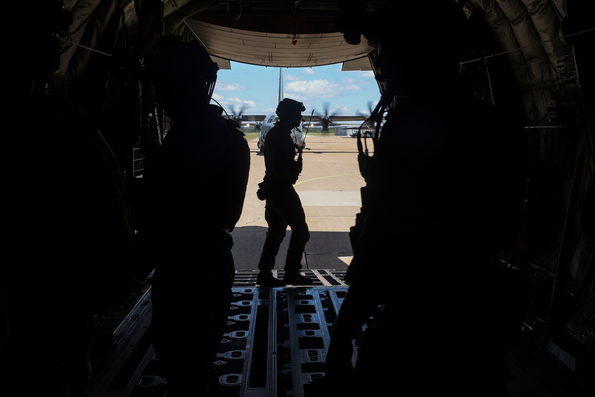 A Special Tactics combat controller from the 24th Special Operations Wing, Hurlburt Field, Florida, exits a C-130J after an airfield seizure operation, May 4, 2017, at an airfield used for resupply of ammunition near Dyess Air Force Base, Texas. The Special Tactics teams integrated air power for the ground force, working with both C-130J Super Hercules and a B-1B Lancer. (U.S. Air Force photo by Staff Sgt. Kaylee Clark)