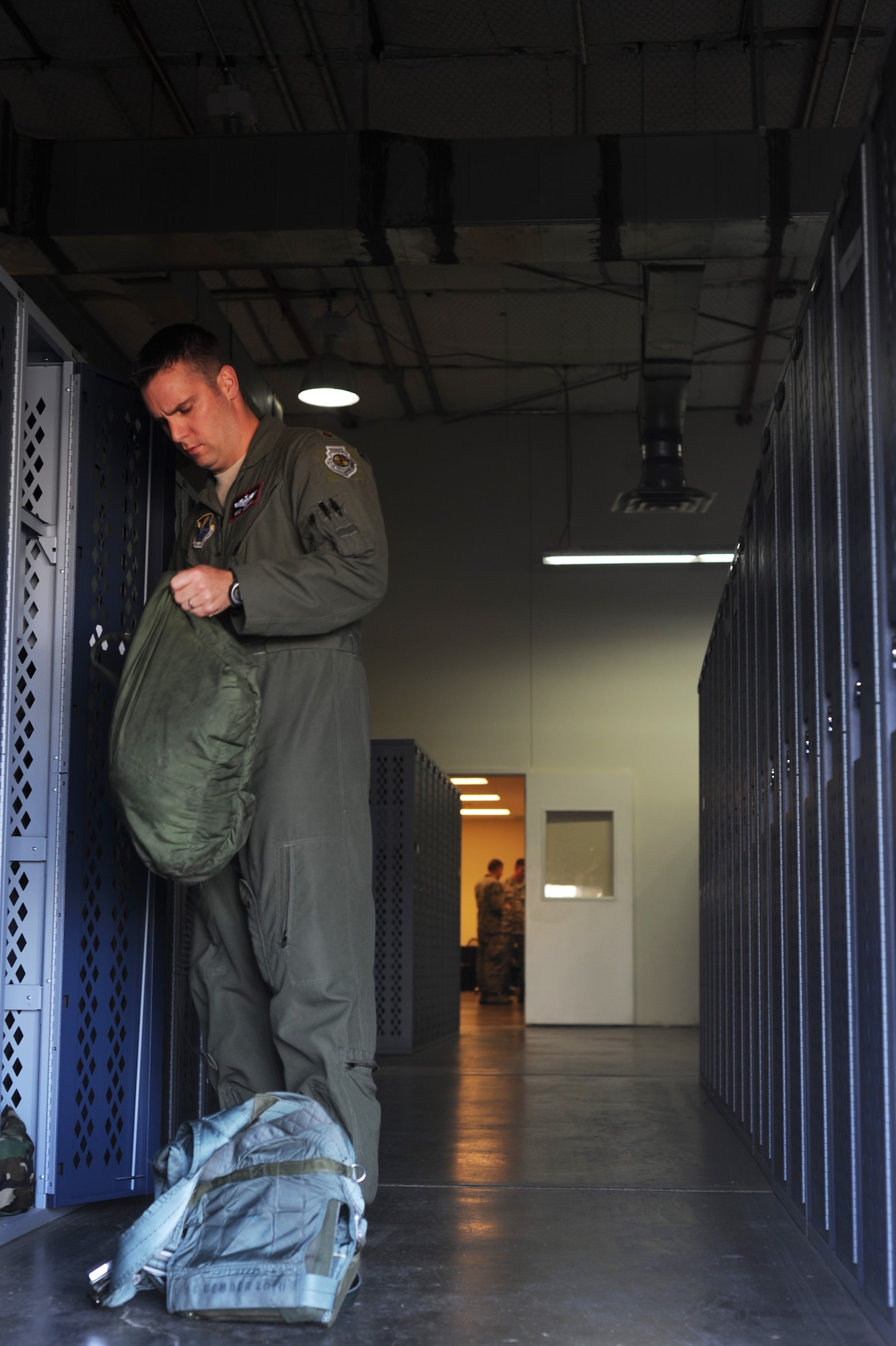 U.S. Air Force Maj. Nathan Jenkins, 7th Operation Support Squadron executive officer, gathers his flight equipment at Dyess Air Force Base, Texas, May 11, 2017. Some of the equipment includes an oxygen mask, helmet and harness. (U.S. Air Force photo by Airman Kylee Thomas)