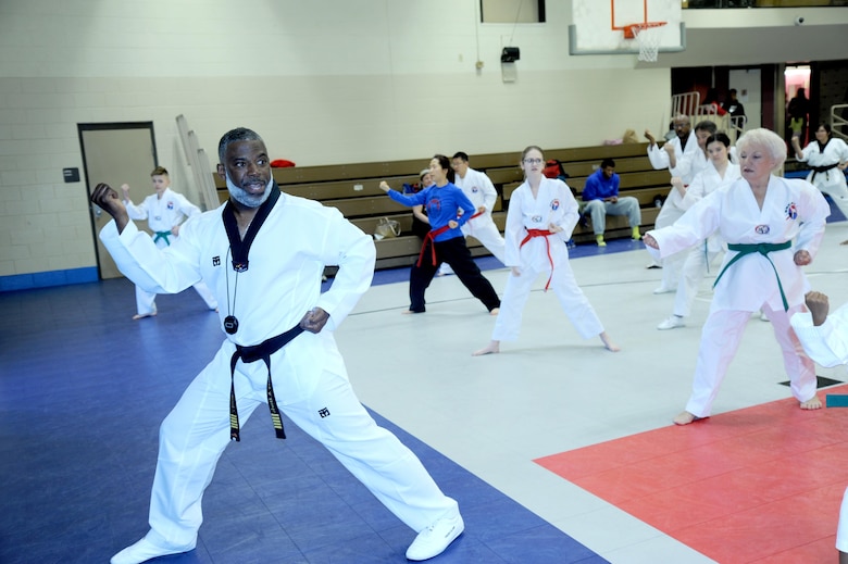 Jeffrey Davis, an emergency management specialist with the U.S. Army Engineering and Support Center, Huntsville, and founder of Rocket Tae Kwon Do, leads students through various martial arts techniques and exercises.