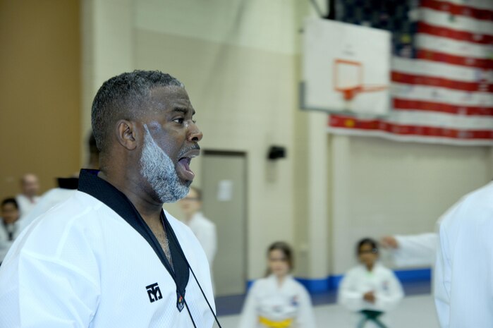 Jeffrey Davis, an emergency management specialist with the U.S. Army Engineering and Support Center, Huntsville, and founder of Rocket Tae Kwon Do, leads students through various martial arts techniques and exercises.