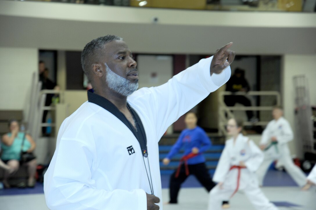 Jeffrey Davis, an emergency management specialist with the U.S. Army Engineering and Support Center, Huntsville, and taekwondo black belt master, leads students through various martial arts techniques and exercises.
