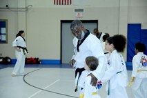 Tatiana Ayala, daughter of Carmen Perez and red belt tae kwon do student, delivers a power punch. Her mother is an employee with the U.S. Army Engineering and Support Center, Huntsville.