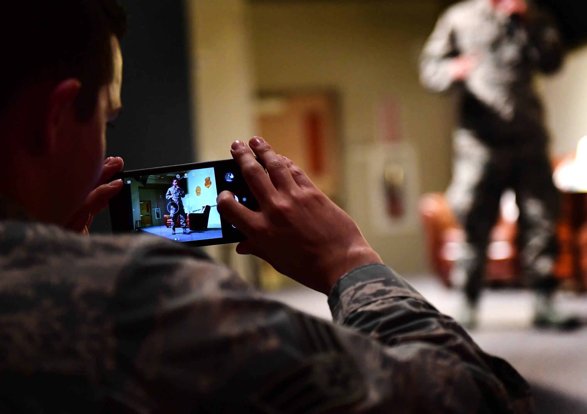 An Airman takes a photo of Tech. Sgt. Jimmy, 78th Attack Squadron intelligence analyst, shares his personal experiences during the first Storytellers event May 10, 2017, at Creech Air Force Base, Nev. Jimmy was involved in a sky-diving accident when his parachute malfunctioned. (U.S. Air Force photo/Senior Airman Christian Clausen)