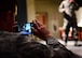 An Airman takes a photo of Tech. Sgt. Jimmy, 78th Attack Squadron intelligence analyst, shares his personal experiences during the first Storytellers event May 10, 2017, at Creech Air Force Base, Nev. Jimmy was involved in a sky-diving accident when his parachute malfunctioned. (U.S. Air Force photo/Senior Airman Christian Clausen)