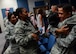 Airmen give Tech. Sgt. Palani, 799th Air Base Squadron NCOIC of vehicle operations, a hug after the first Storytellers event May 10, 2017, at Creech Air Force Base, Nev. Palani shared his experiences as a child and overcoming the adversity of having a drug-addicted father and survived molestation as a child. (U.S. Air Force photo/Senior Airman Christian Clausen)