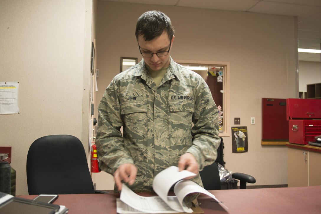 EIELSON AIR FORCE BASE, Alaska – U.S. Air Force Airman 1st Class Johnathan Pein, a 335th Aircraft Maintenance Unit aircrew flight equipment technician assigned to Seymour Johnson Air Force Base, N.C., checks a daily flying log during NORTHERN EDGE 2017 (NE17), at Eielson Air Force Base, Alaska. NE17 is Alaska’s premier joint training exercise designed to practice operations, techniques and procedures as well as enhance interoperability among the services. Thousands of participants from all the services, Airmen, Soldiers, Sailors, Marines and Coast Guardsmen from active duty, Reserve and National Guard units are involved. (U.S. Air Force photo/Staff Sgt. Ashley Nicole Taylor)
