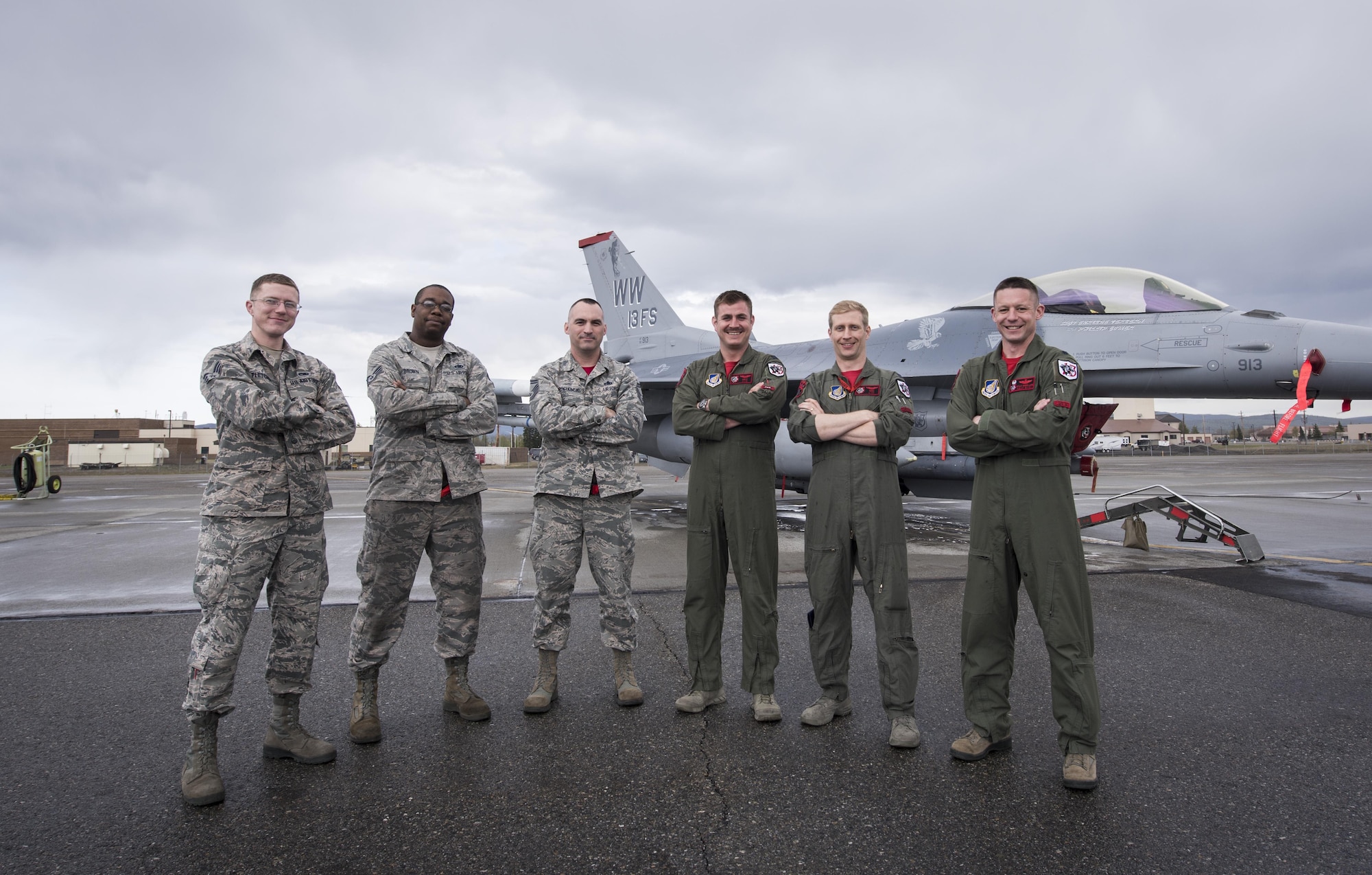 Senior Airman Brenden Fletcher, a 35th Maintenance Squadron sheet metal specialist, Staff. Sgt. Anthony Brown, a 13th Aircraft Maintenance Unit engine mechanic, Senior Master Sgt. Daniel Grochowsk, a 13th Aircraft Maintenance Unit lead production superintendent, Capt.’s Matthew Harris and Mark Jaszczak both 13th Fighter Squadron pilots and Lt. Col. Christopher Moeller, 13th Fighter Squadron commander pose in front of F-16 Flying Falcon that was down diverted to King Salmon on Apr. 26, 2017. (U.S. Air Force photo by Tech. Sgt. Araceli Alarcon)