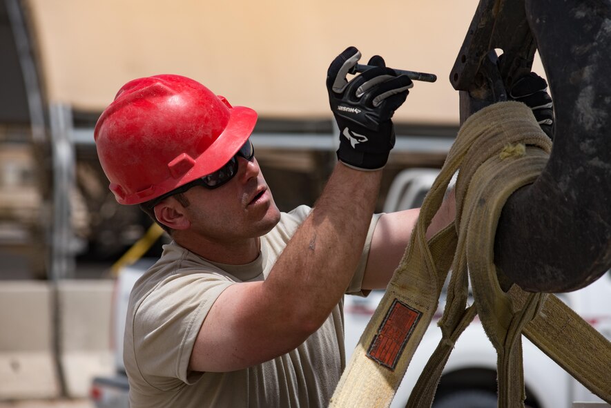 Tech. Sgt. Travis Monks, a heating, ventilation and air conditioning technician and NCO in charge of HVAC installs with the 407th Expeditionary Civil Engineer Squadron, secures an air conditioning unit to a crane hook, May 4, 2017, in Southwest Asia. The new cooling system will provide cooled air to an operations building at the 407th Air Expeditionary Group in time for the significant rise of summer temperatures in the region. Monks is member of the Air Force Reserve and deployed from March Air Reserve Base in Riverside, Calif. (U.S. Air Force photo by Staff Sgt. Alexander W. Riedel)