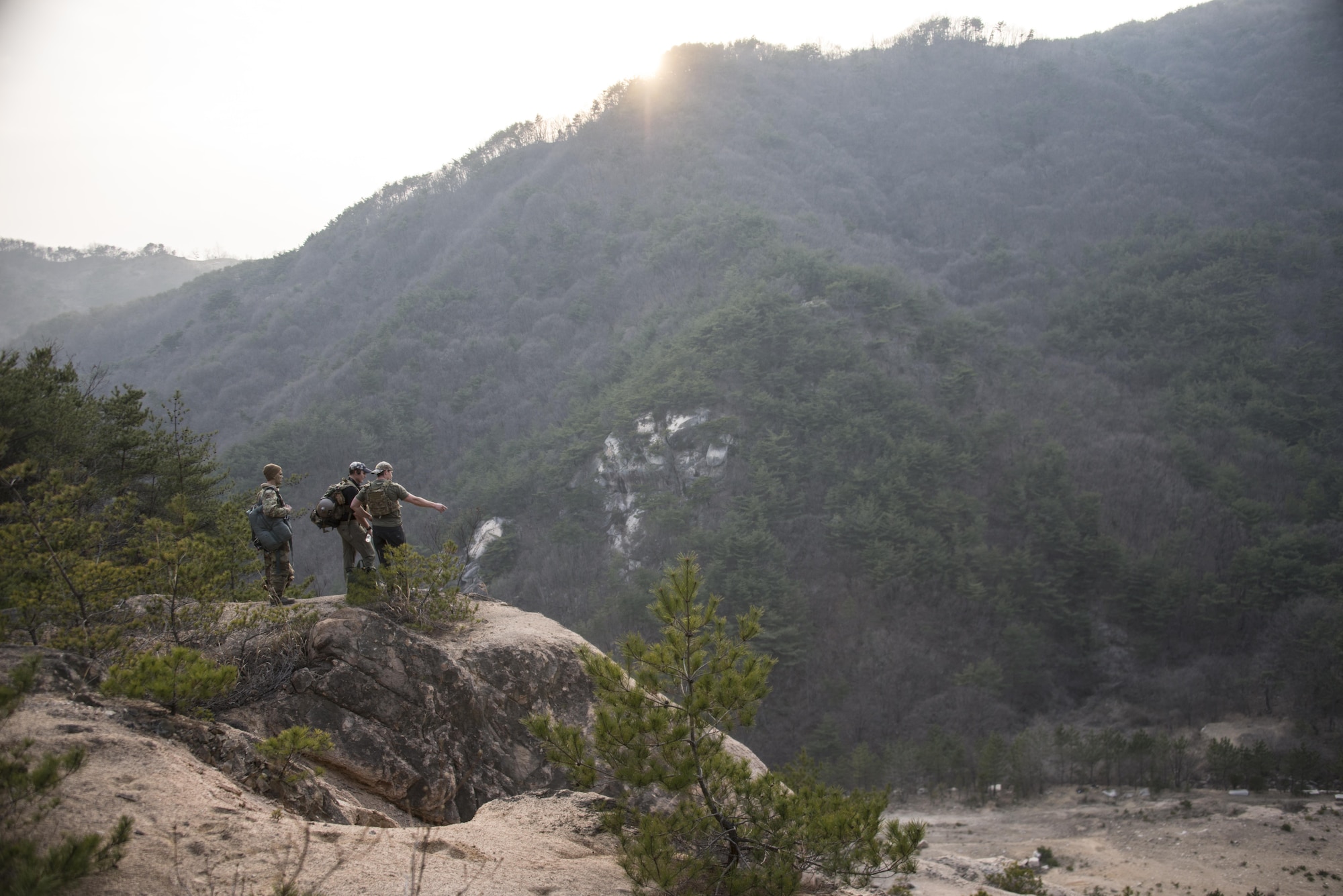 A U.S Air Force 353rd Special Operations Support Squadron survival, evasion, resistance and escape (SERE) instructor and a 320th Special Tactics Squadron pararescueman, prepare the environment for the personnel recovery event, March 30, 2017. The simulated aircraft crash landing provided aircrew the opportunity to perform hands-on SERE training to keep them current in the knowledge and skill level needed to return with honor. (U.S. Air Force photo by Capt. Jessica Tait)