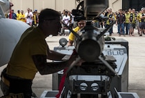 U.S. Air Force Senior Airman Rhaymark Neri, 80th Aircraft Maintenance Unit weapons load crew member, raises a bomb in place while Staff Sgt. Dylan Ducharme, 80th Aircraft Maintenance Unit weapons load crew member, observes and guides the bomb into place during the 2017 annual weapons load crew competition at Kunsan Air Base, Republic of Korea, May 13, 2017. The annual load competition tests objectives like safety, speed, and cleanliness to enhance PACAF’s and ROKAF’s mission of always being ready to fight tonight. (U.S. Air Force photo by Senior Airman Colville McFee/Released)  